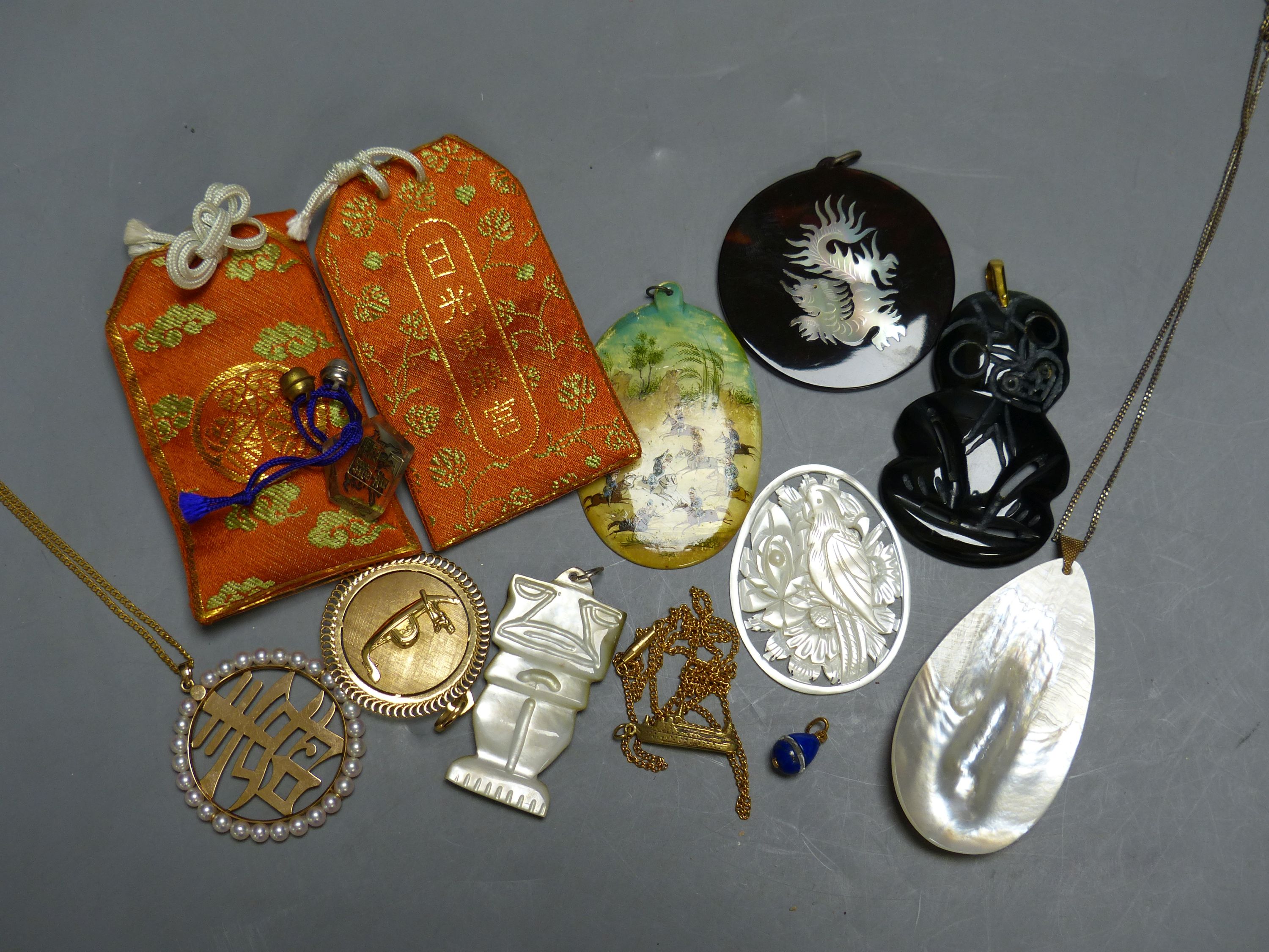 Miscellaneous decorative items, including a Mughal oval miniature on mother of pearl of polo players, a black painted hardstone tiki